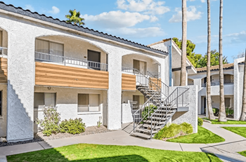 A white building with a balcony and a staircase at Tides on East Cactus Apartments, Arizona, 85032
